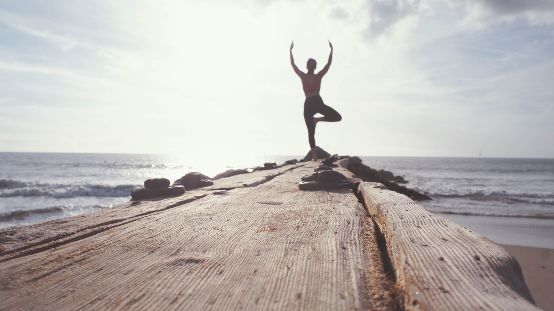 a person standing on top of a sandy beach